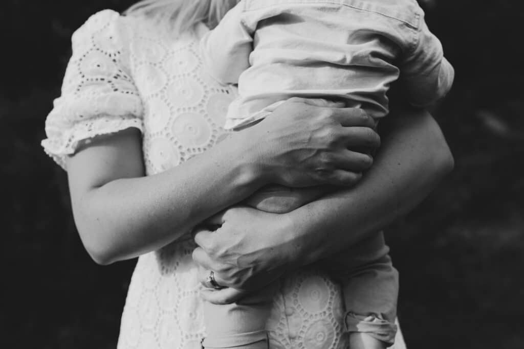 close up of mum holding her little son on her arms. Black and white image of mum and son connection. basingstoke photographer. Ewa Jones Photography