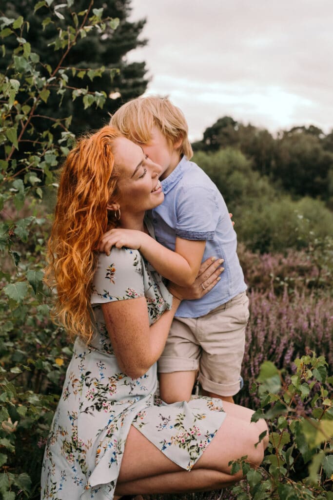 Mum and son are close to each other and son is cuddling his mum. Lovely late summer mum and child photo session in Hook, Hampshire. Hampshire photographer. Ewa Jones Photography