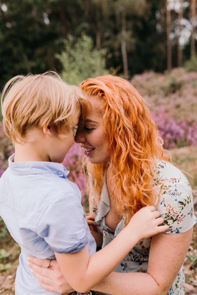 Mum and son is cuddling close to each other and are close with their foreheads. Mum and son photo session in Hampshire. Ewa Jones Photography