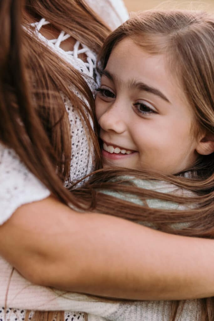 LIttle girl is cuddling close to her mum. Family photo shoot in Hampshire. Basingstoke photographer. Ewa Jones Photography