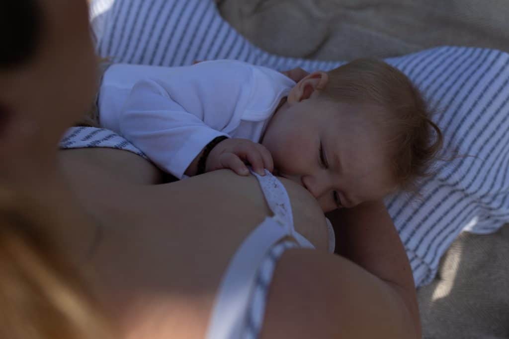 Mum is breastfeeding her baby boy. mummy and me photoshoot in Basingstoke, Hampshire. newborn photographer in Basingstoke. Ewa Jones Photography