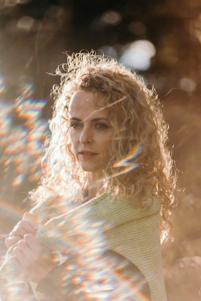 Female is looking away and the sun is shining beautifully. natural woman photo session in Hampshire. Ewa Jones Photography