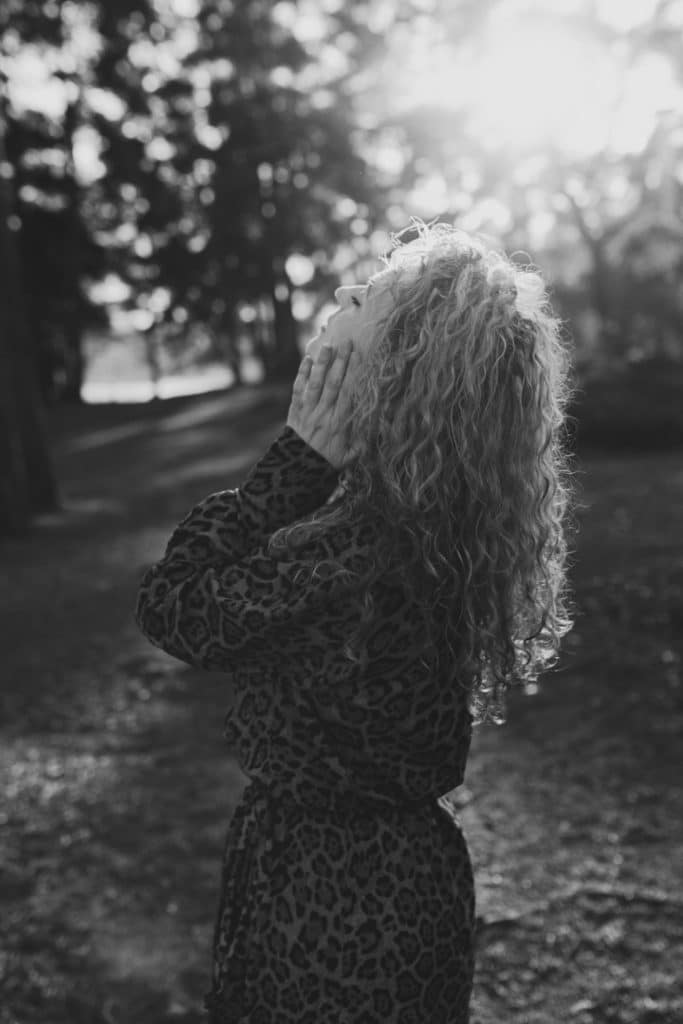 Black and white image of a woman touching her neck. Female photo shoot in Hampshire. Ewa Jones Photography