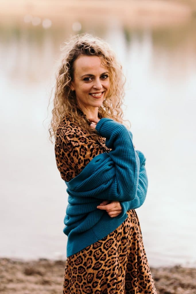 Female is wearing black and brown dress and smiling to the camera. Female photo session with Fi. Female photographer in Hampshire. Ewa Jones Photography