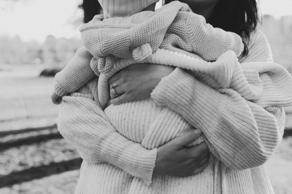 Mum is hugging tightly her baby boy. candid and natural photograph of mum and baby. Basingstoke photographer. Ewa Jones Photography