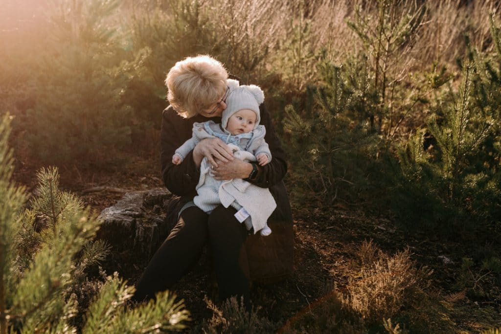 Grandma is kissing her grandson on his head. Lovely candid natural photograph. Family photo shoot in Hampshire. Ewa Jones Photography