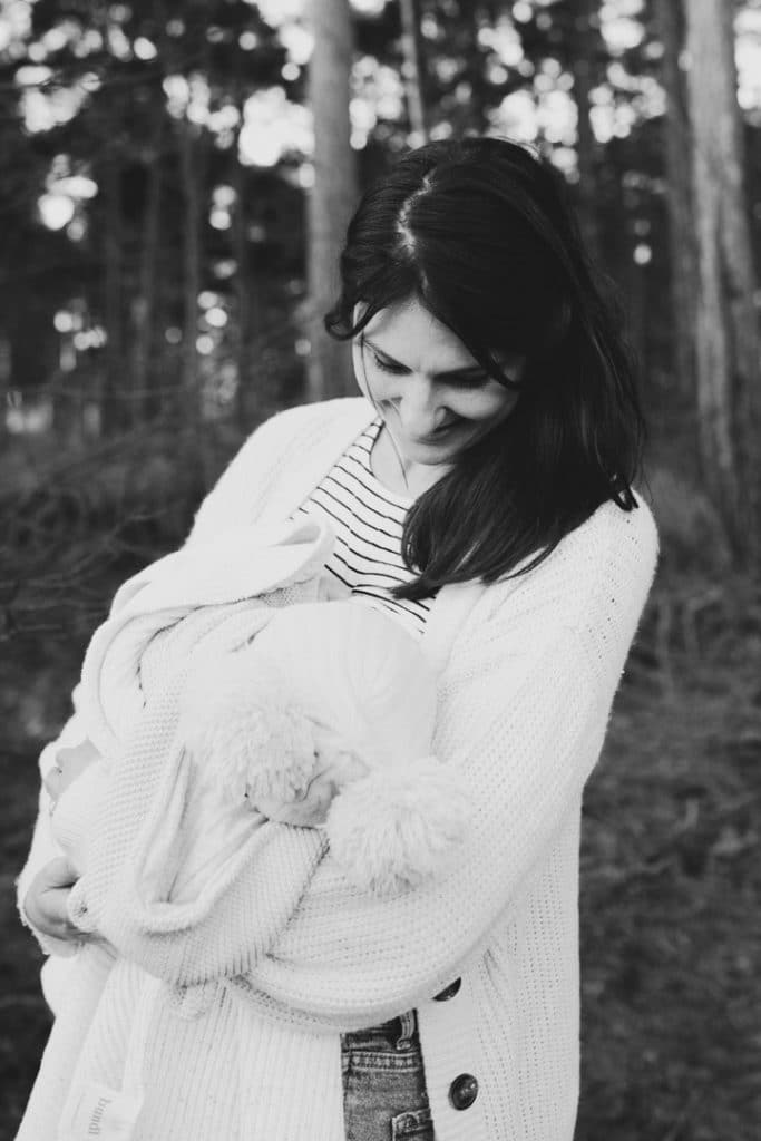 Mum is breastfeeding her baby boy. Black and white image. Family photographer in Hampshire. Ewa Jones Photography