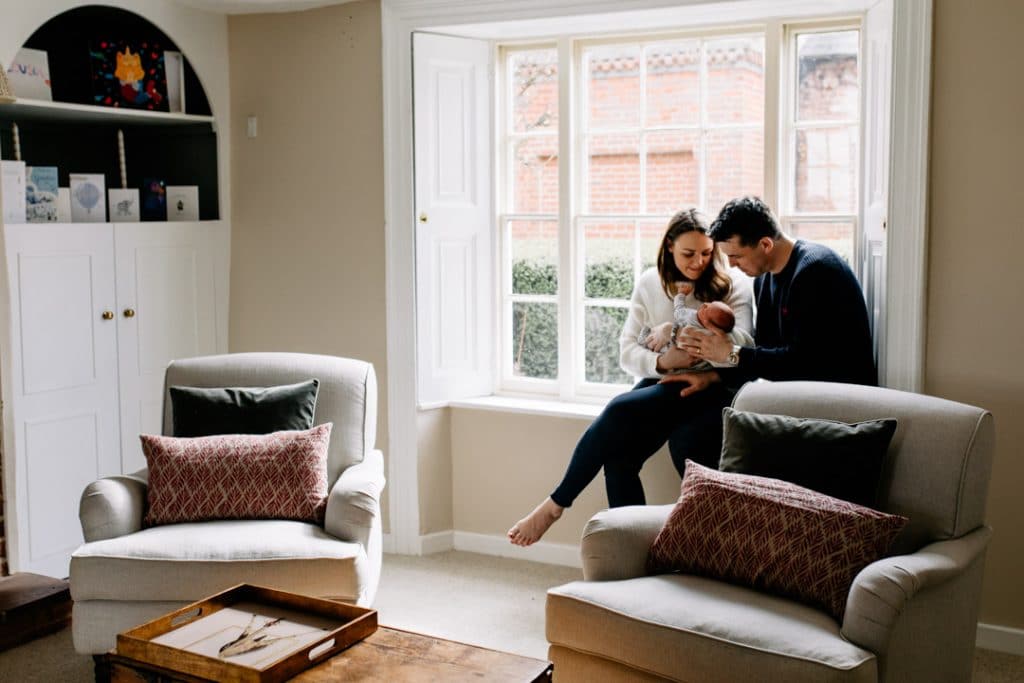 New parents are holding newborn baby in their arms. Lifestyle newborn photoshoot in Hampshire. Basingstoke photographer. Ewa Jones Photography