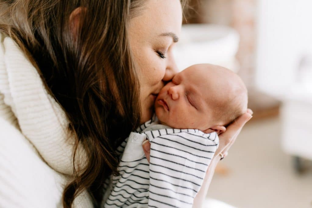 mum is kissing her newborn baby boy. basingstoke photographer. Ewa Jones Photography