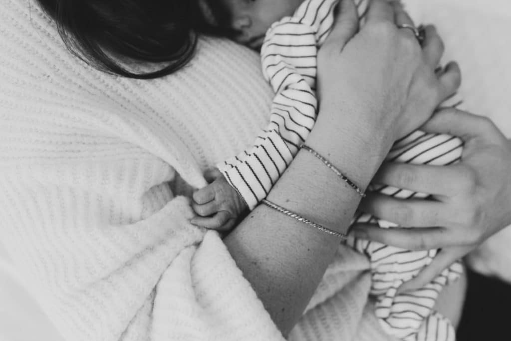 Close up detail of newborn baby boy holding onto mummy's jumper. Newborn photographer in Basingstoke. Ewa Jones Photography