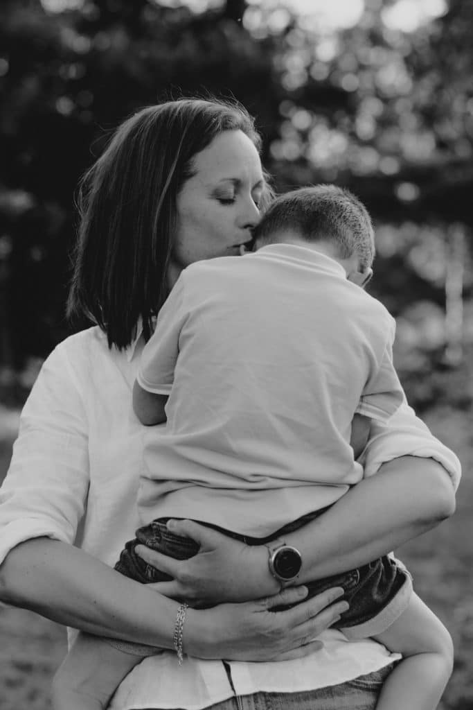 Mum is cuddling her boy. black and white family photography. Family photographer in Basingstoke. Ewa Jones Photography