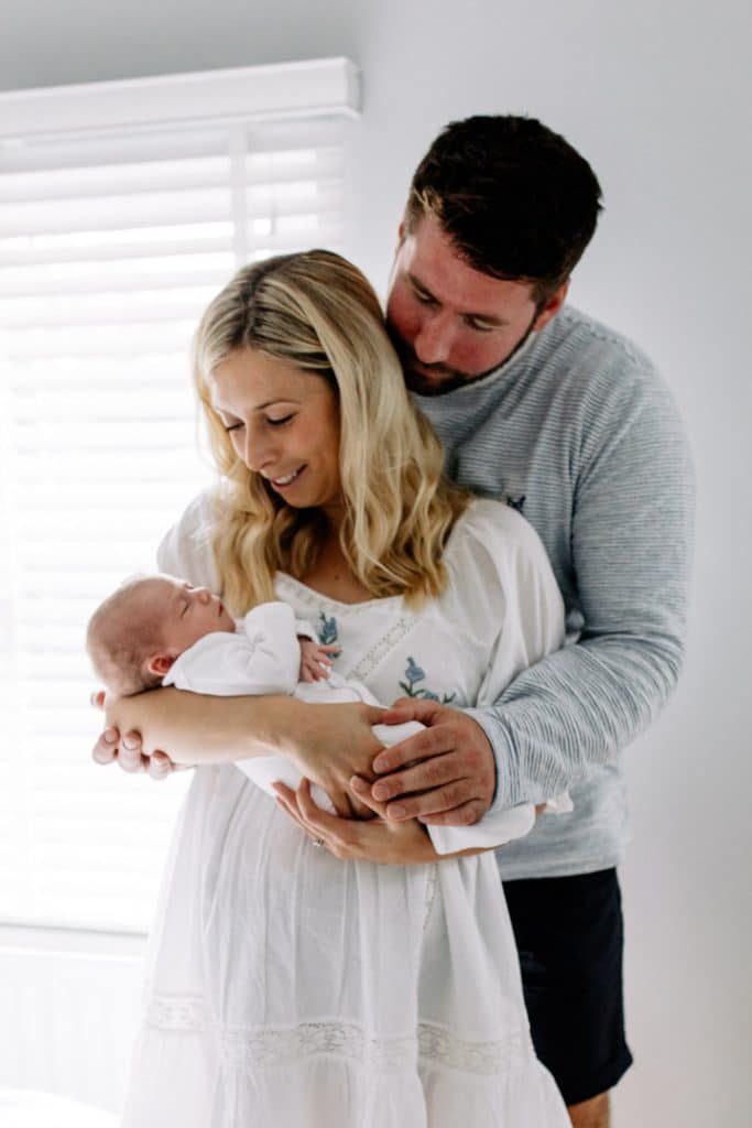 family cuddles during newborn photo session in wokingham. Ewa Jones Photography