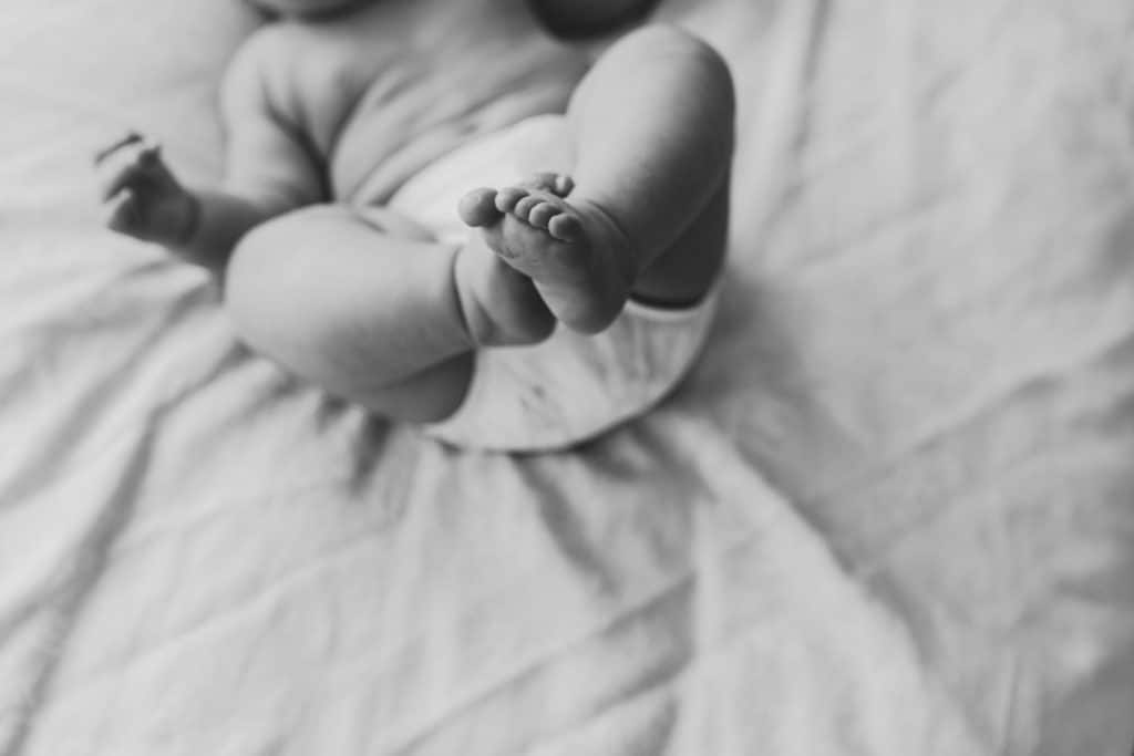 black and white image of baby feet. Newborn photographer in Basingstoke, Hampshire. Ewa Jones Photography