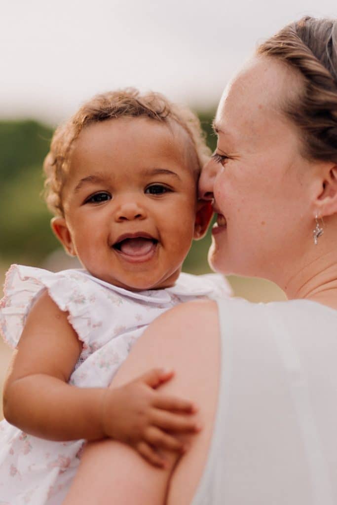 mum is cuddling up to her baby girl. Lovely natural image of mum and daughter. Family photographer in Hampshire. Basingstoke family photographer. Ewa Jones Photography