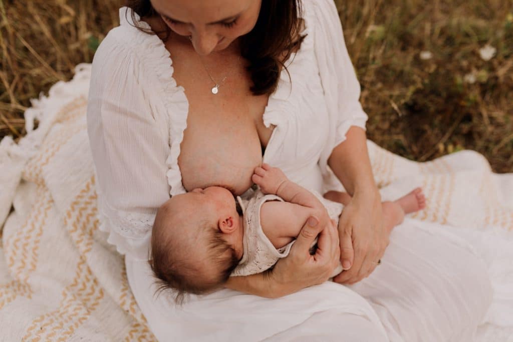 Mum is breastfeeding her little baby girl. Breastfeeding week. Group breastfeeding photo session inspirations. Hampshire photographer. Breastfeeding photo session in Hampshire. Ewa Jones Photography