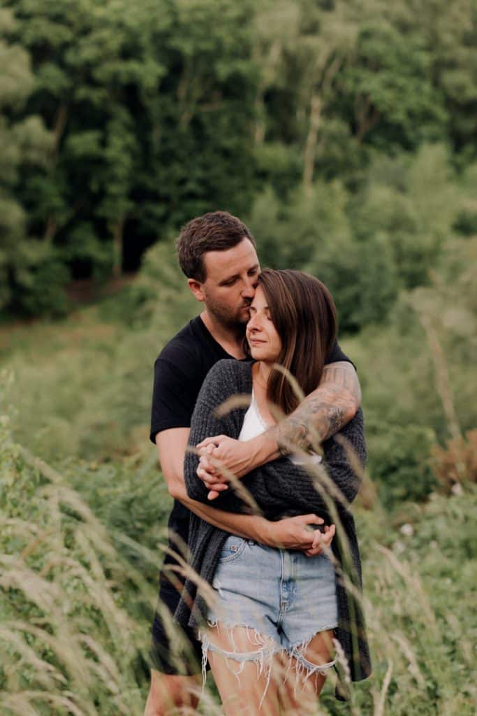 Couple is cuddling. lovely natural location for an engagement photo shoot. couple photographer in Hampshire. Ewa Jones Photography. couple photography in Hampshire.