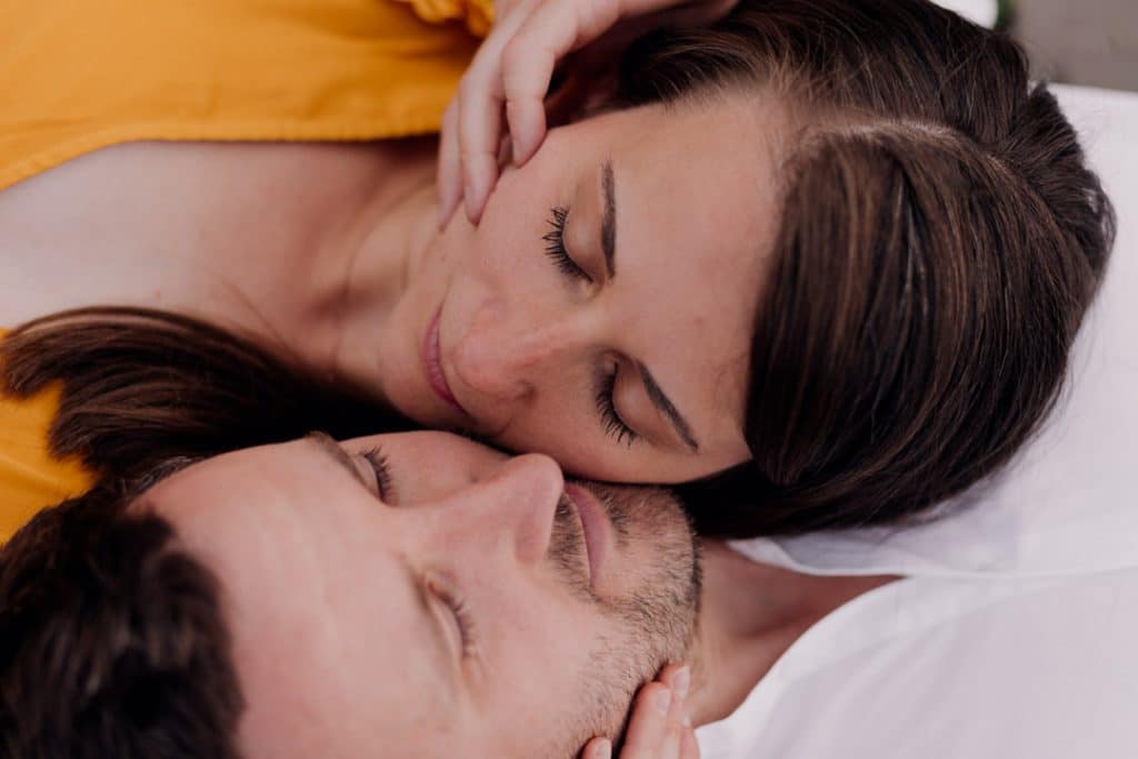 Female and male are laying on the floor and have their heads close to each other. Natural lifestyle couple photo shoot in Hampshire. Ewa Jones Photography