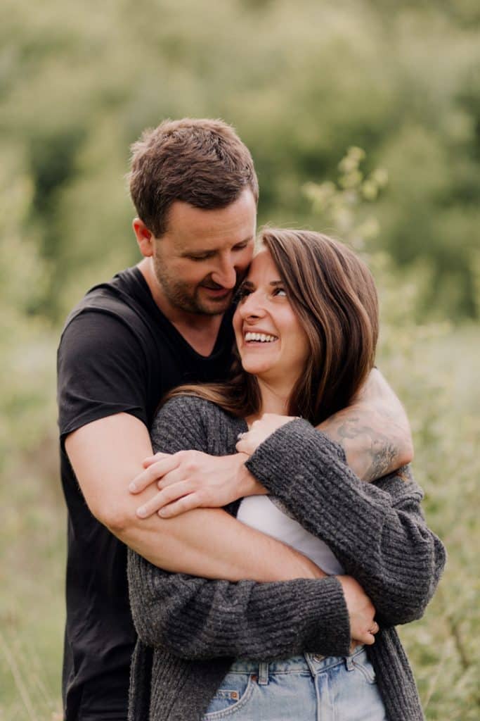couple is cuddling and smiling to each other. natural lifestyle couple photography. Ewa Jones Photography