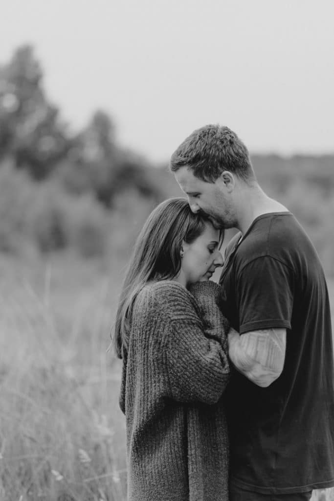 couple is cuddling close. black and white photography. engagement photo shoot. Hampshire photographer. Ewa Jones Photography