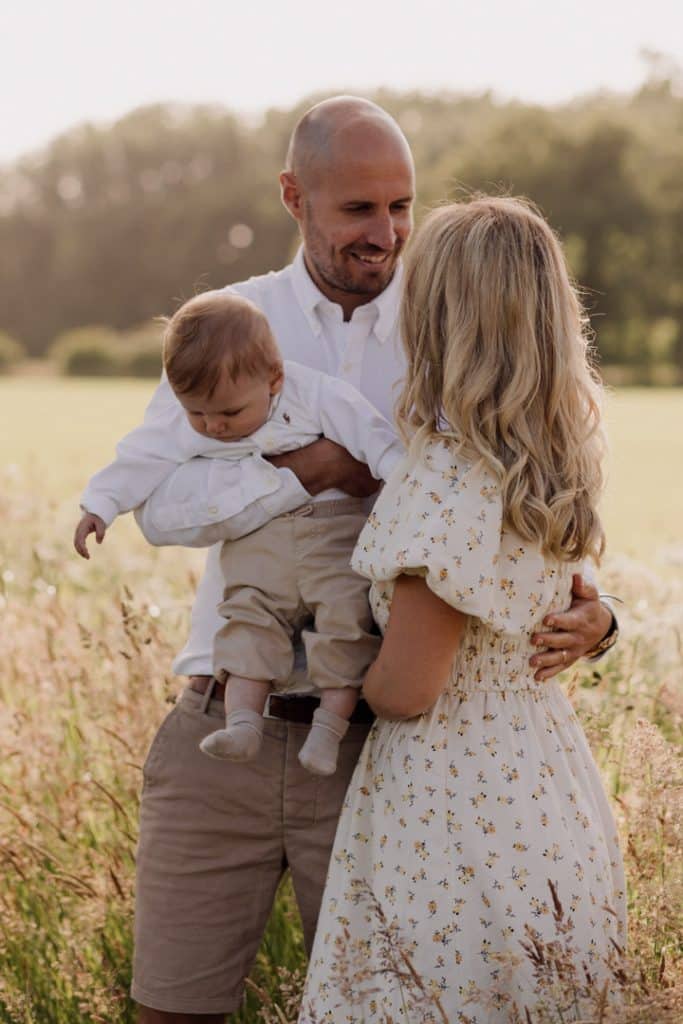 Family photo session in Hampshire countryside-13 family is cuddling in the field of wild flowers. Family photo session in Hampshire. Basingstoke photographer. Ewa Jones Photography