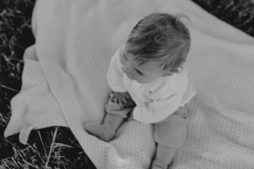 Family photo session in Hampshire countryside-8 black and white image of boy sitting on the blanket. Hampshire photographer. Ewa Jones Photography