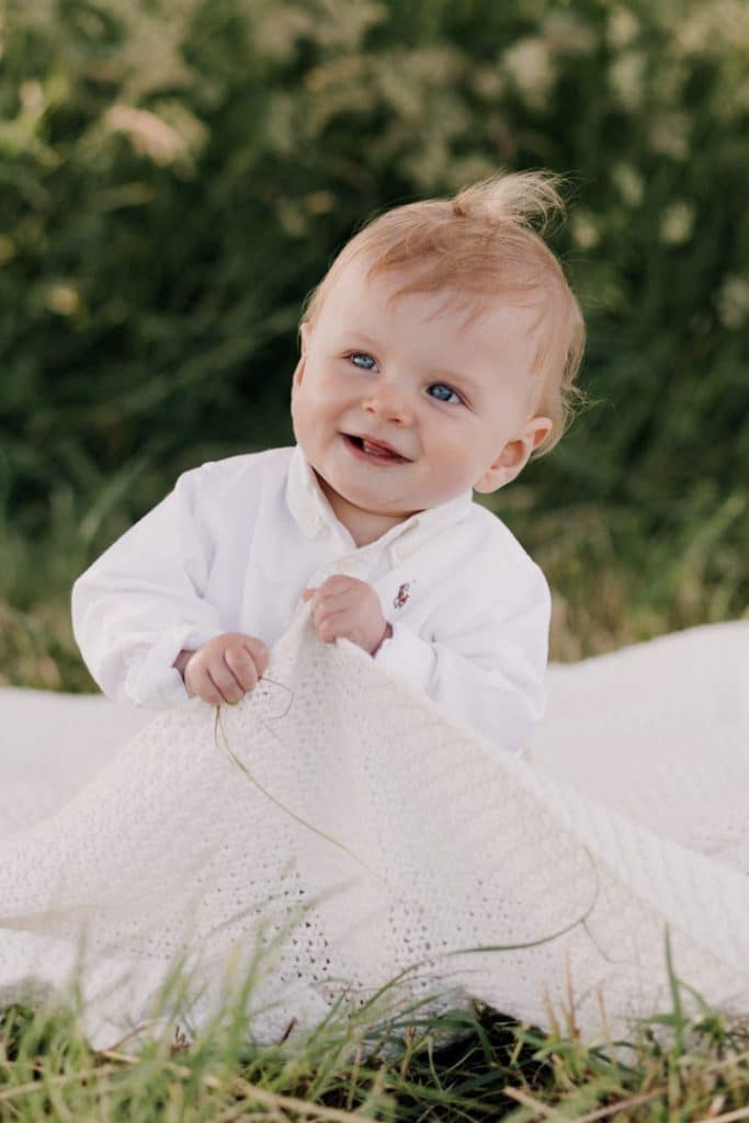 Family photo session in Hampshire countryside-9 Little boy is sitting on the blanket and looking up. Family photo session in Hampshire countryside. Basingstoke family photographer. Ewa Jones Photography