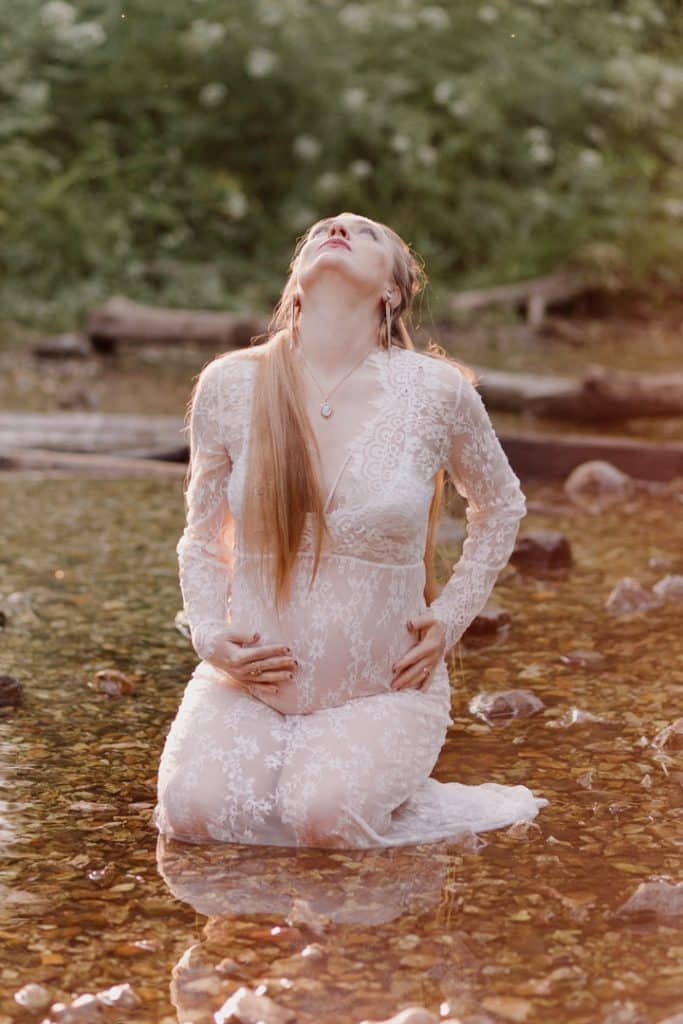 Maternity photo session - Grace and Chris-20 maternity photo session. Mum is sitting in the water and looking down at her bump. Maternity photographer in Hampshire. Hampshire photographer. Ewa Jones Photography
