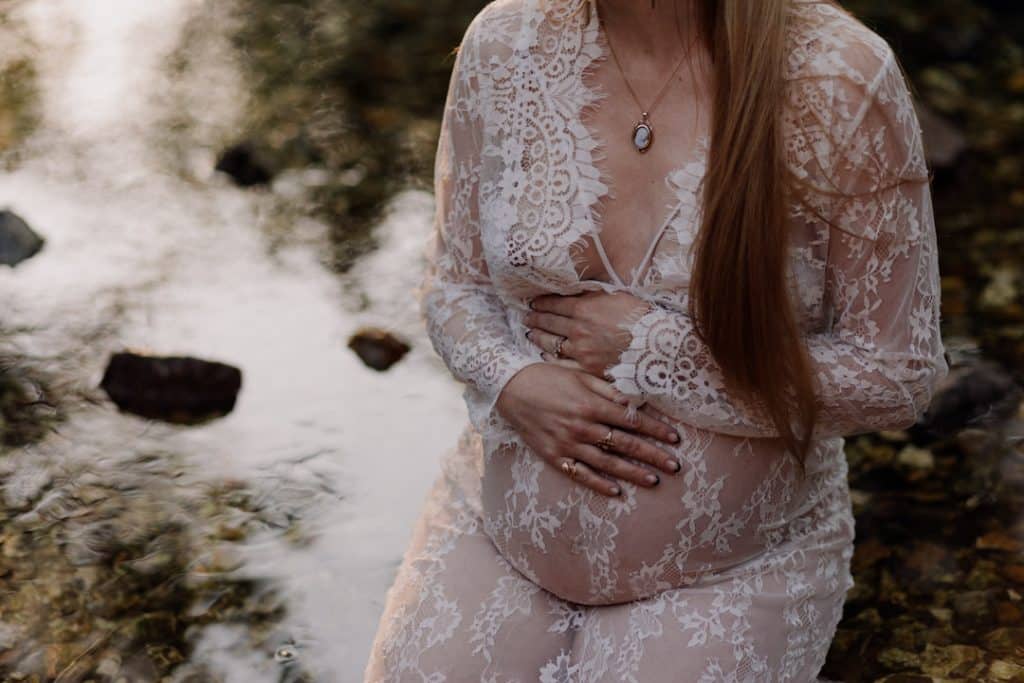 Maternity photo session - Grace and Chris-22 maternity photo session. Mum is sitting in the water and looking down at her bump. Maternity photographer in Hampshire. Ewa Jones Photography