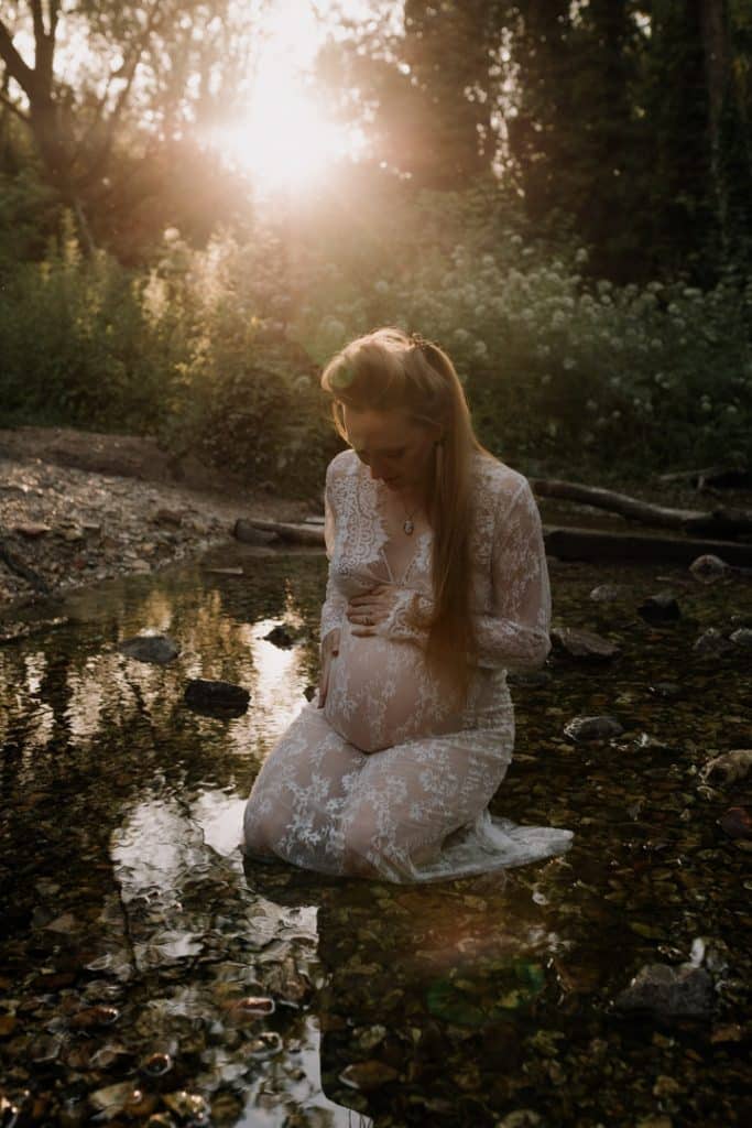 Maternity photo session - Grace and Chris-23 maternity photo session. Mum is sitting in the water and looking down at her bump. Maternity photographer in Hampshire. Ewa Jones Photography