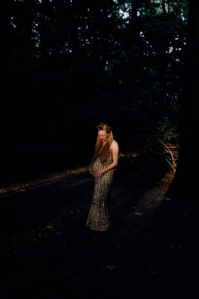 Maternity photo session - Grace and Chris-24 Pregnant mum is wearing beautiful dress and standing in the forest. Lovely sun is beaming down on her. Maternity photo session out of this world. Maternity photo session in Hampshire. Ewa Jones Photography