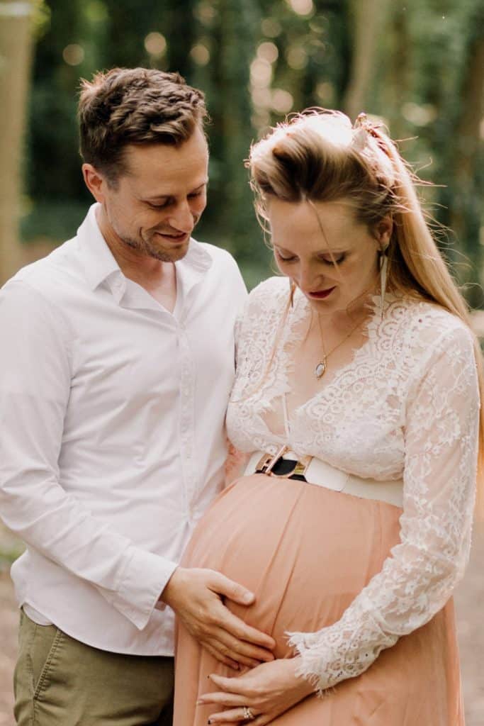 Maternity photo session - Grace and Chris-4 Mum and dad are looking at their baby bump and smiling. Maternity poses ideas. Maternity photo shoot. Basingstoke photographer. Ewa Jones Photography