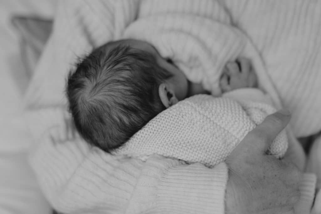 Mum is breastfeeding her baby girl. Black and white photograph. Newborn photo session. Newborn photography in Hampshire. Ewa Jones Photography
