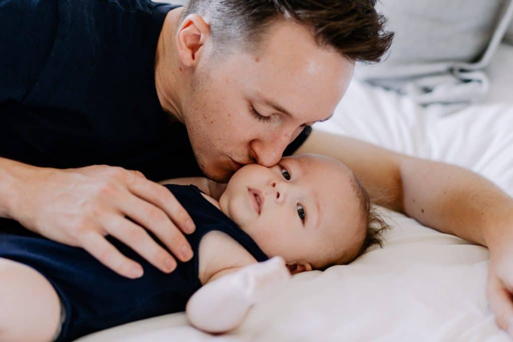 Dad is kissing his baby boy in the cheek. Baby photo sessions in Hampshire. Hampshire photographer. Ewa Jones Photography