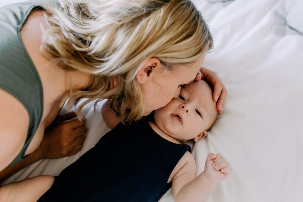 mum is kissing her baby boy on his cheek. Newborn photoshoot. Hampshire photographer. Ewa Jones Photography