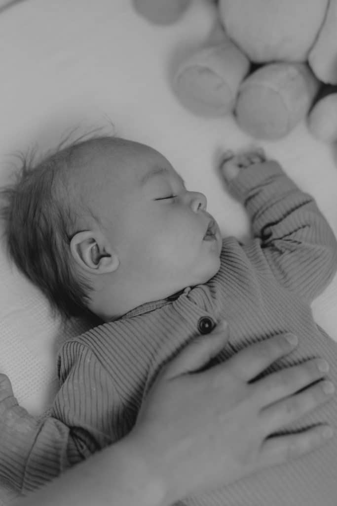 baby boy is sleeping. close up image of baby in the cot. Hampshire photographer. Ewa Jones Photography