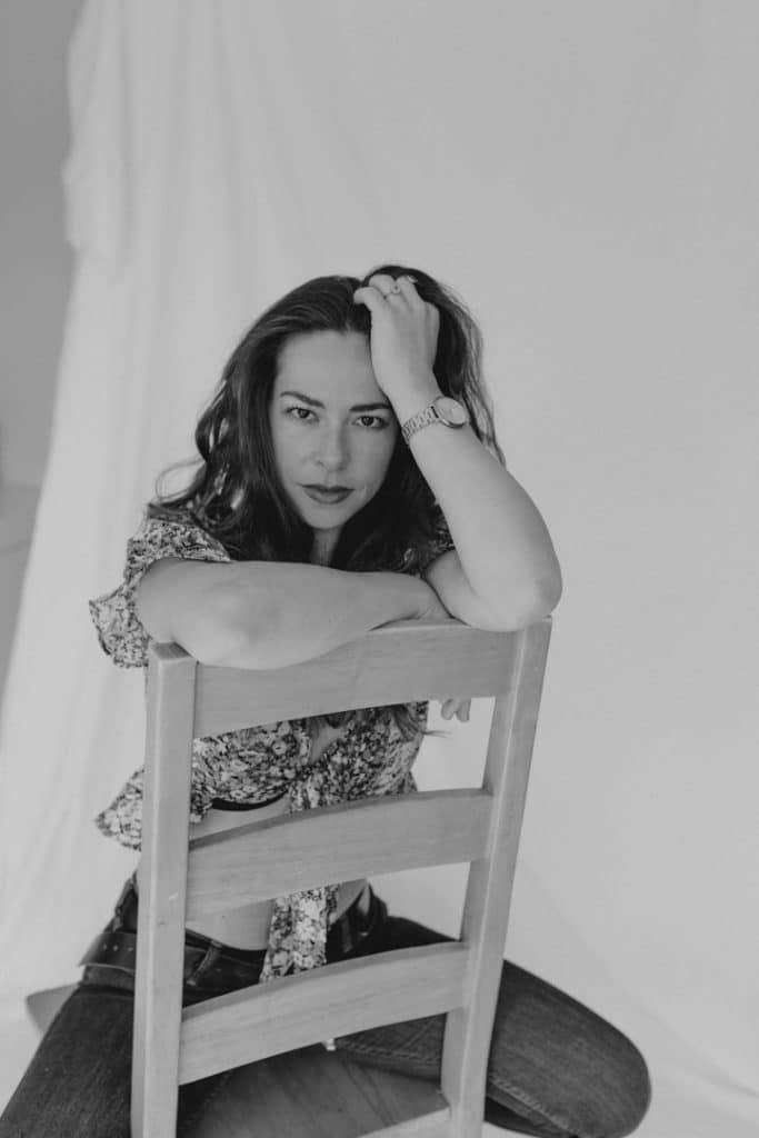 woman is sitting on the chair and looking at the photographer. portrait female photo session. model photo session. Model photographer. Women photography in Hampshire. Ewa Jones Photography