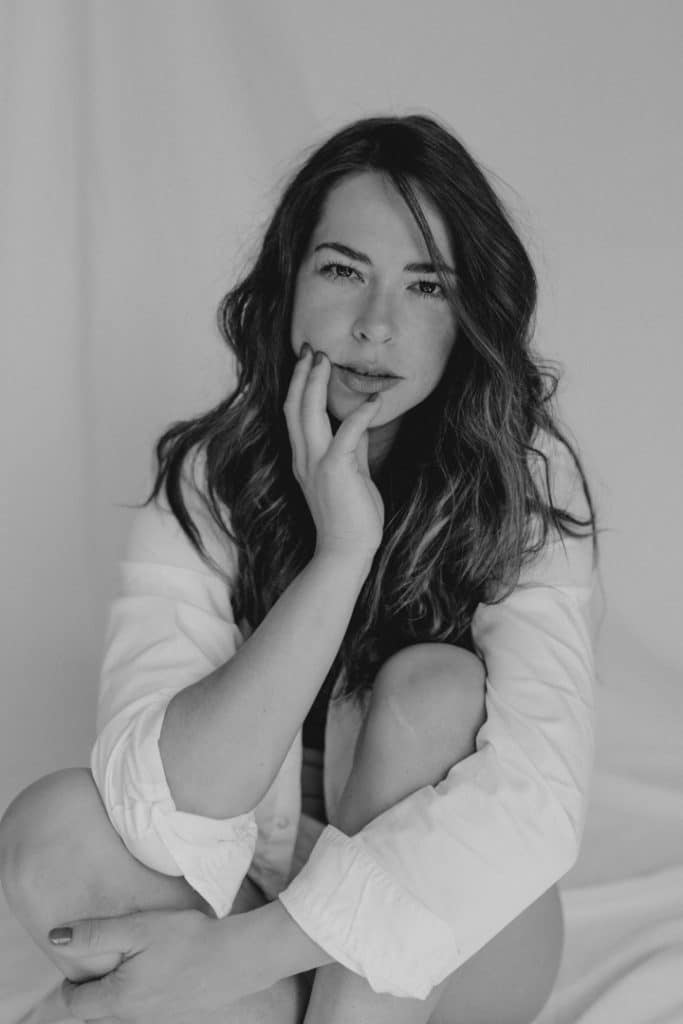 femle poses. woman is sitting and hugging her legs. she is looking at the camera. portrait female photo session. model photo session. Model photographer. Women photography in Hampshire. Hampshire photographer. Ewa Jones Photography