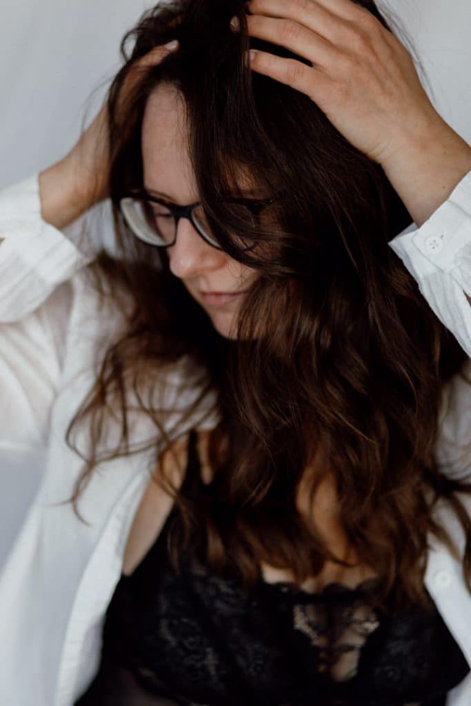 female is looking lovely and touching her hair. portrait photo shoot in Basingstoke hampshire. boudoir female photo session. Hampshire phtoographer. Ewa Jones Photography