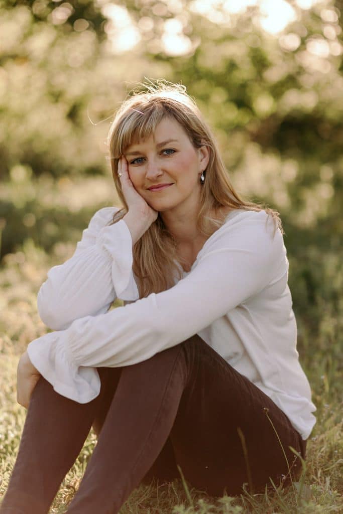 Female is sitting on the grass and looking at the camera.. Empowering female photo sessions. Female photo session in Basingstoke hamsphire. Hampshire photographer. Basingstoke female photographer.Ewa Jones Photography