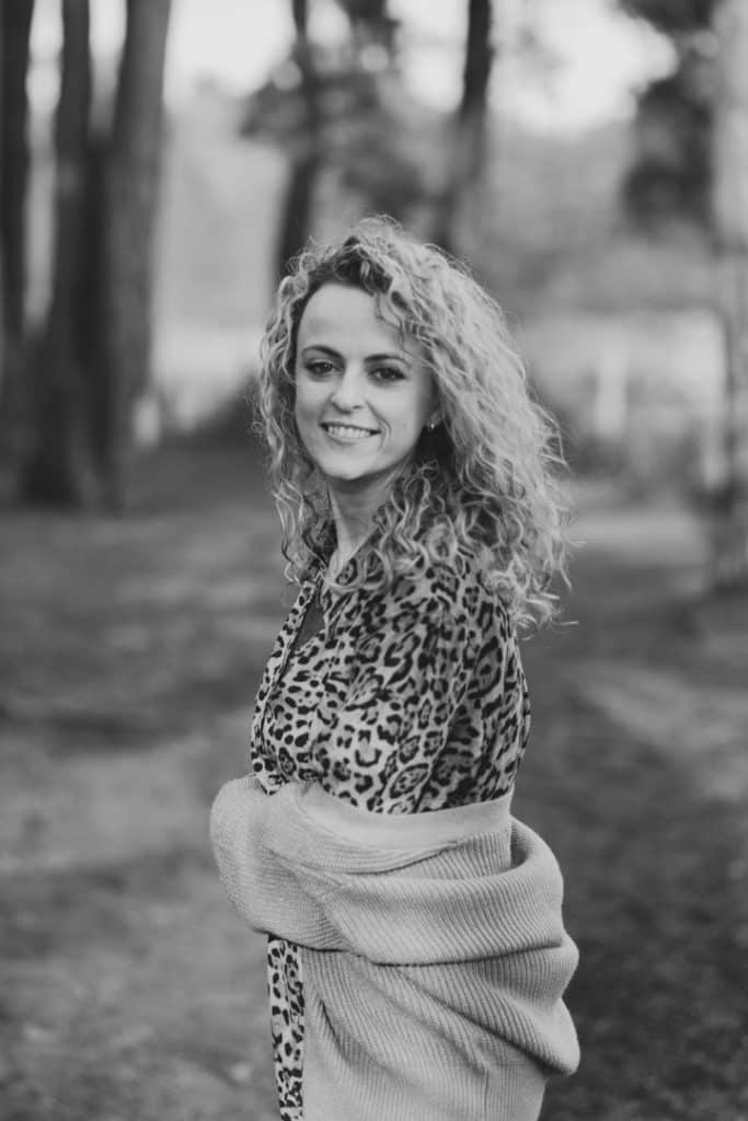 Woman is looking at the camera. She is wearing lovely dress and cardigan. Empowering female photo session. Hamsphire woman photographer. Ewa Jones Photography