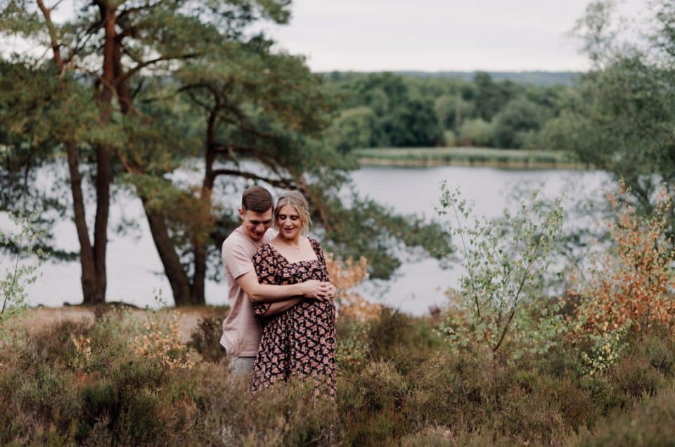 Expecting couple is cuddling and standing close to each other. Lovely natural lifestyle maternity photo session. Hampshire photographer. Ewa Jones Photography. Bump and newborn photo session