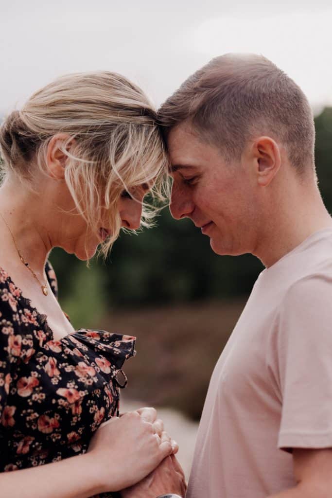 female and man are looking down and holding hands tight. Maternity photo session in Hampshire. Hampshire maternity photographer. Ewa Jones Photography