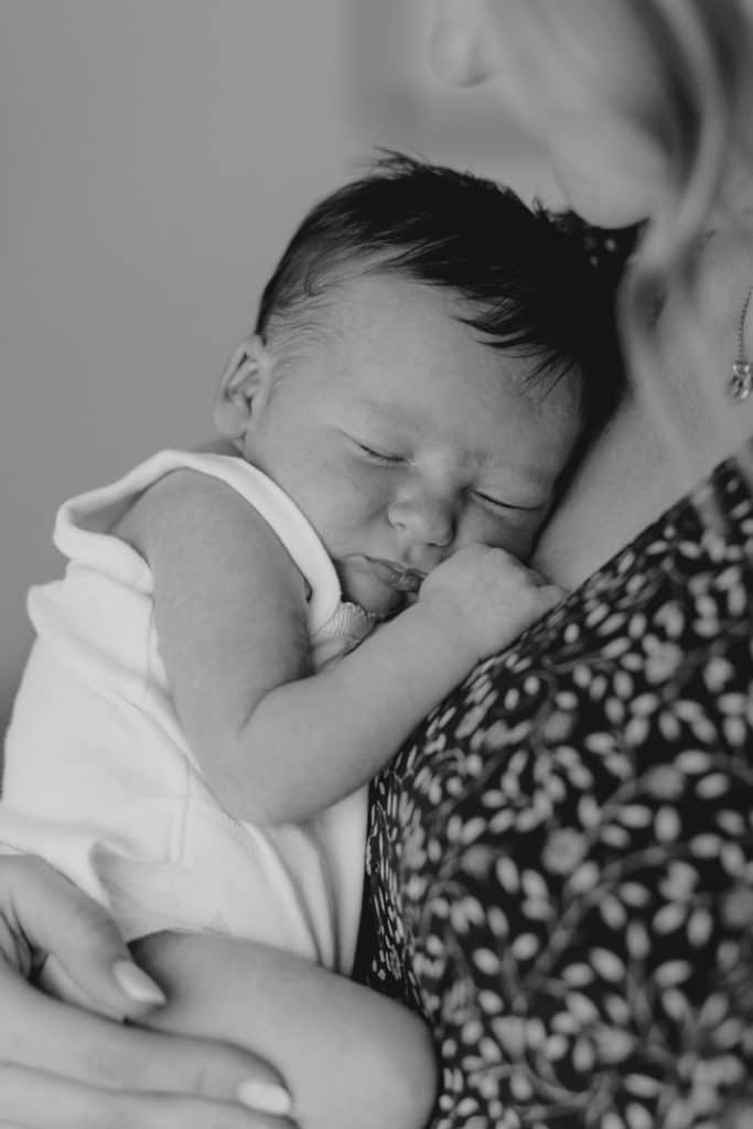 Lovely image of newborn baby being held by mum. Close up image showing beautiful love. Newborn photo session in Hampshire. Newborn photographer in Basingstoke. Ewa Jones Photograpehy