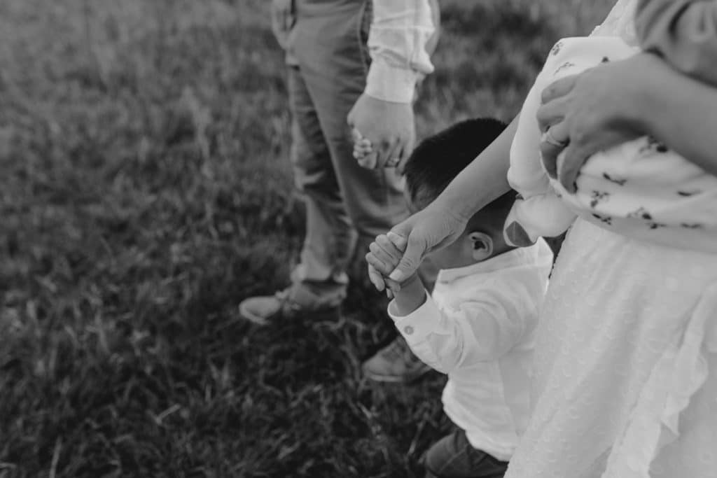 close up detail of family walking and holding hands. Family photo shoot in Surrey. Family photo session in September. Hampshire family photographer. Ewa Jones Photography