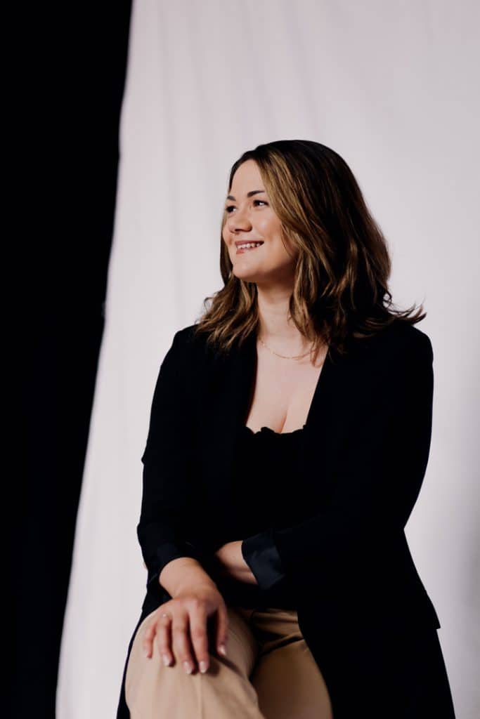 Female is sitting on the chair and smiling. Lovely female photo session in Basingstoke Hampshire. Ewa Jones Photography