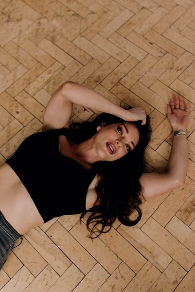Female is laying on the floor and looking at the camera. Female photoshoot in Hampshire. Model photographer. Hampshire photographer. Ewa Jones Photography