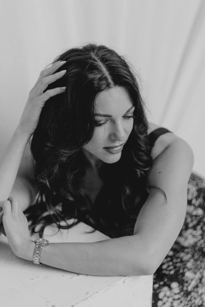 Black and white image of a female looking down and thinking. Model portfolio. Hampshire photographer. Ewa Jones Photography