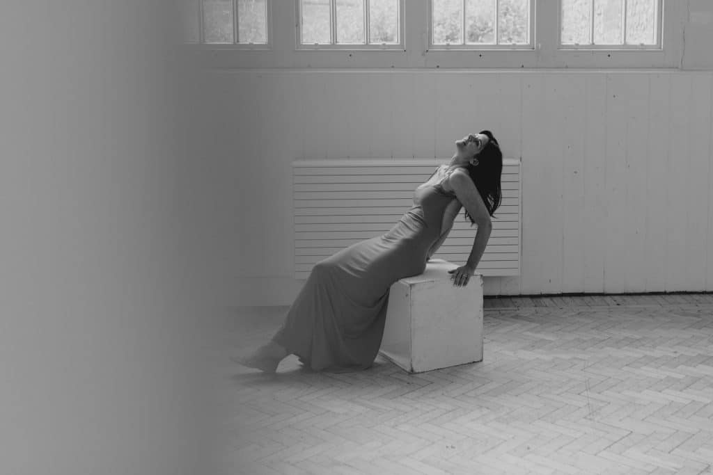 Female is looking up and wearing lovely long dress. Female photo session in Basingstoke Hampshire. Hampshire female photographer. Ewa Jones Photography