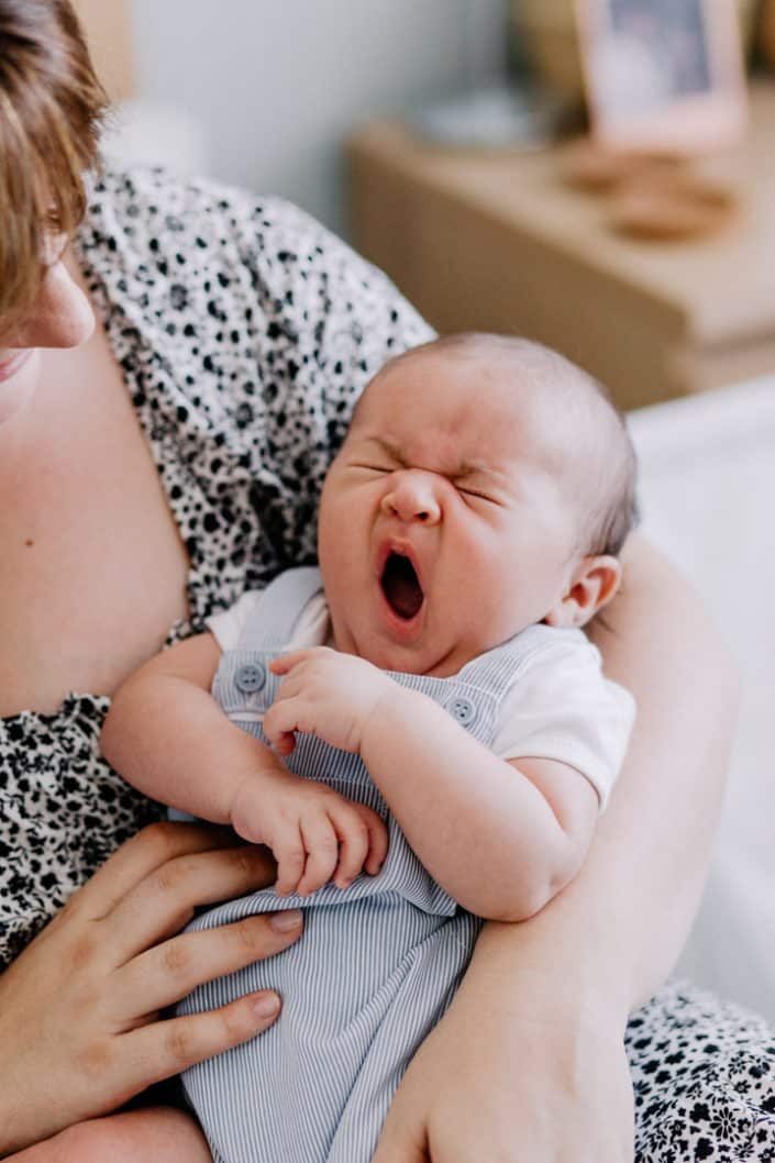 Newborn baby boy is yawning. Natural newborn photo shoot at home. Newborn photographer in Basingstoke Hampshire. Ewa Jones Photography