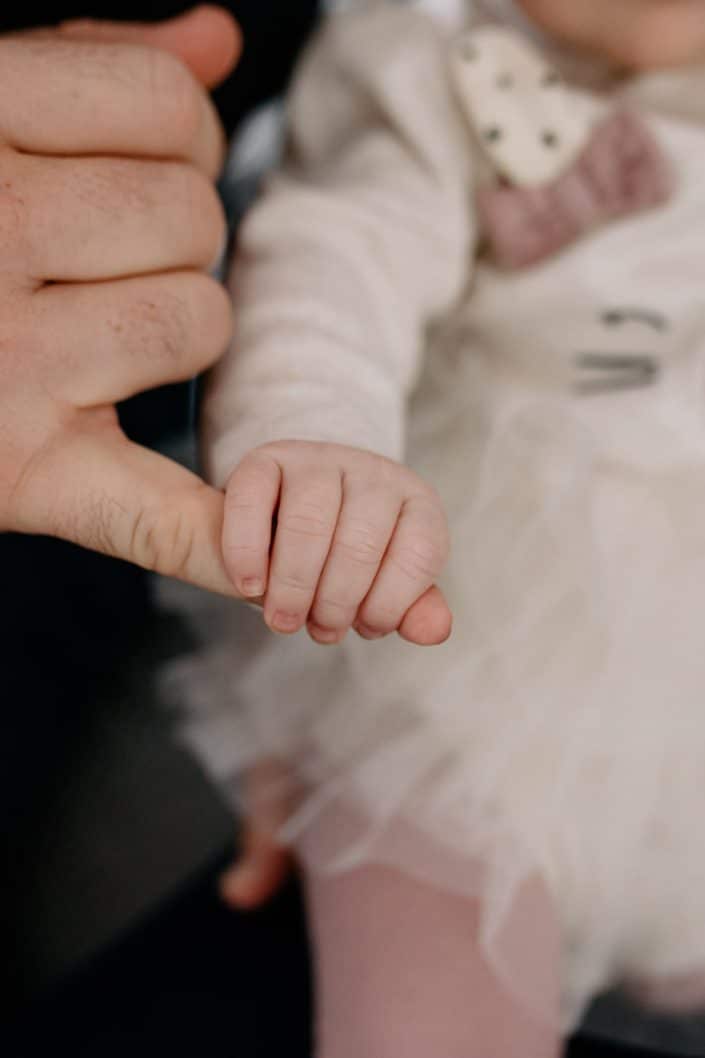 Close up detail of newborn baby girl holding dads finger. Lifestyle newborn photo shoot in Hampshire. Hampshire newborn photographer. Ewa Jones Photography